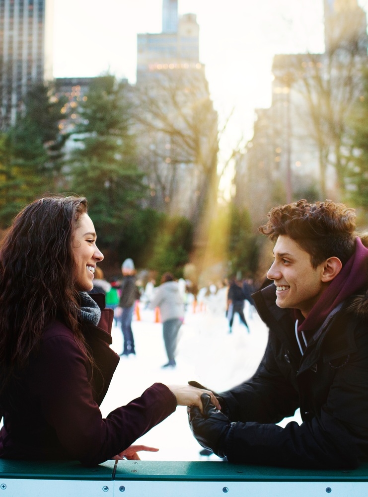 Couple sharing a moment with Midtown Manhattan skyline as backdrop.