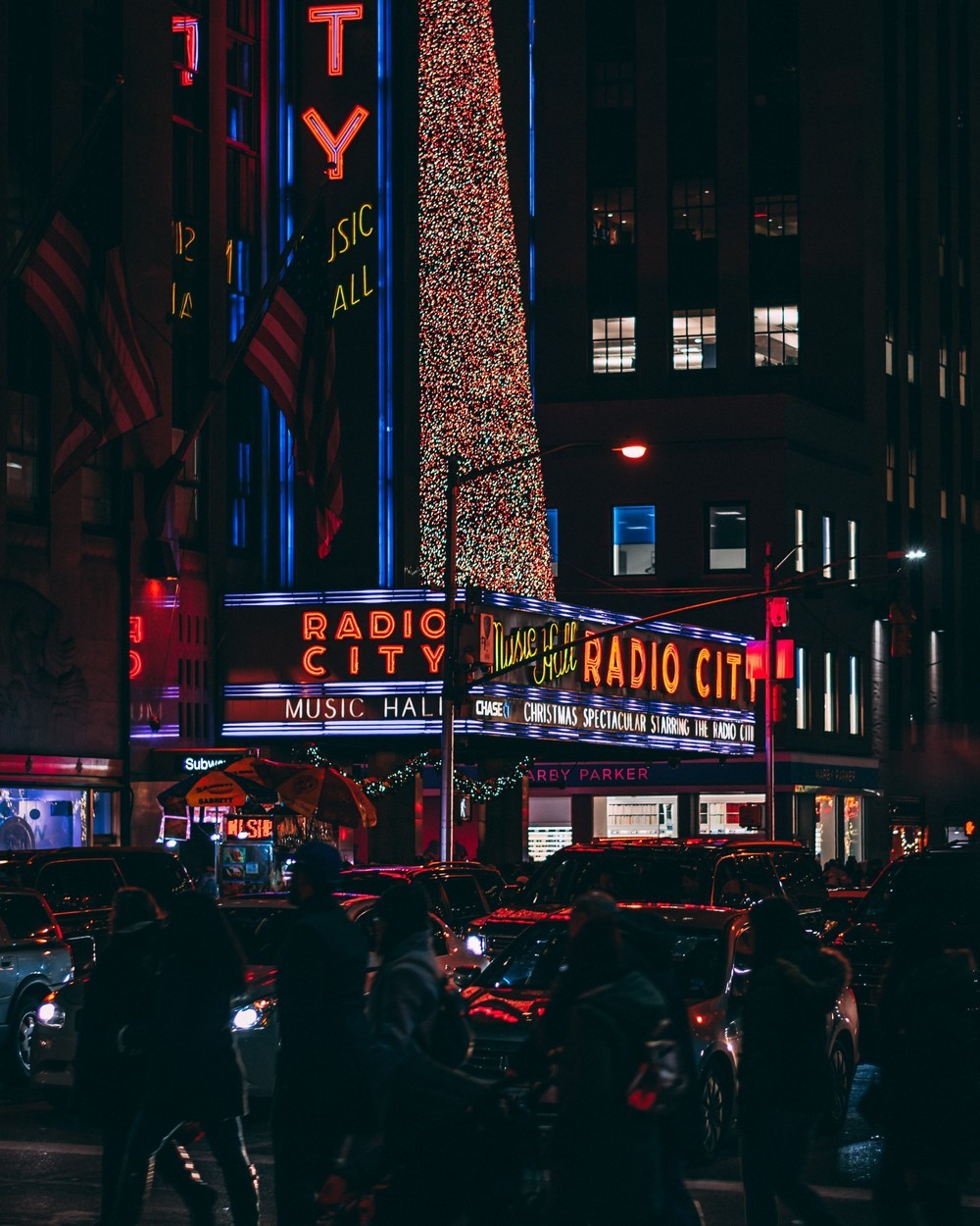 New York City decorated with holiday lights, featuring ice skating at Rockefeller Center and festive Christmas shows.