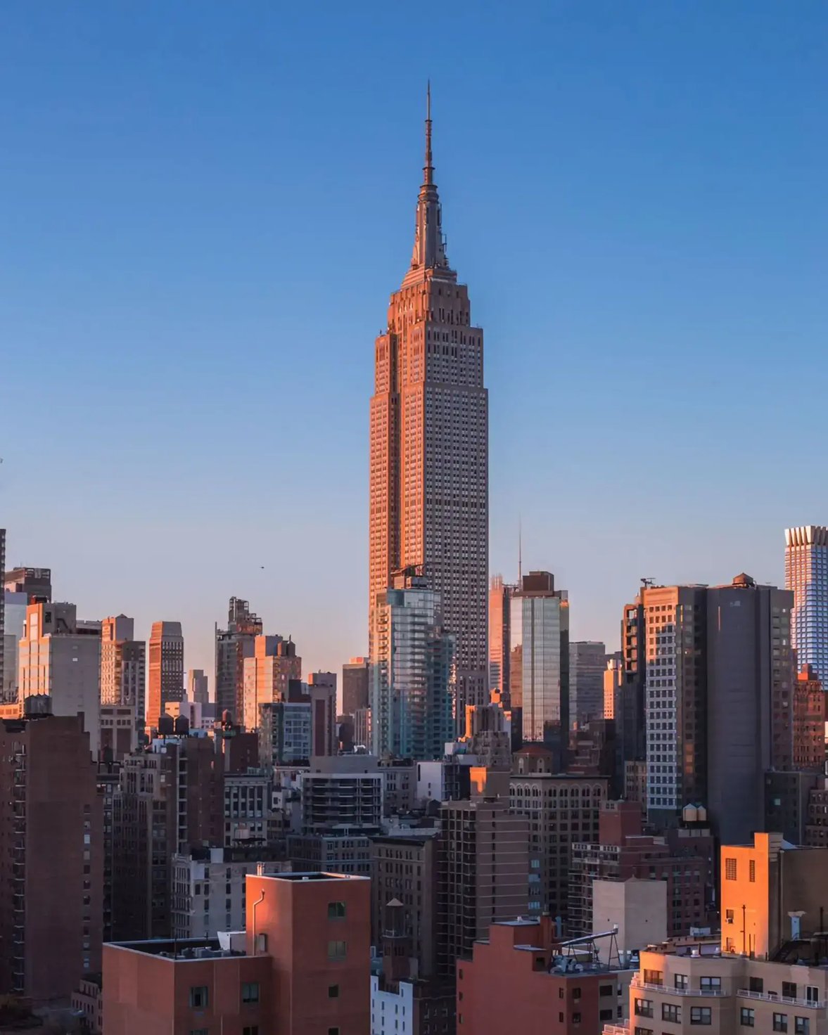 View of New York City's skyline featuring the Empire State Building at sunset